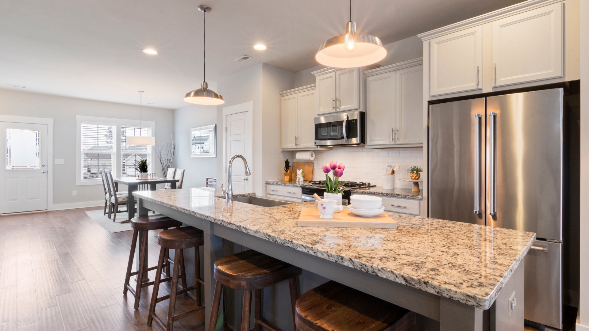 A kitchen with a center island with stools